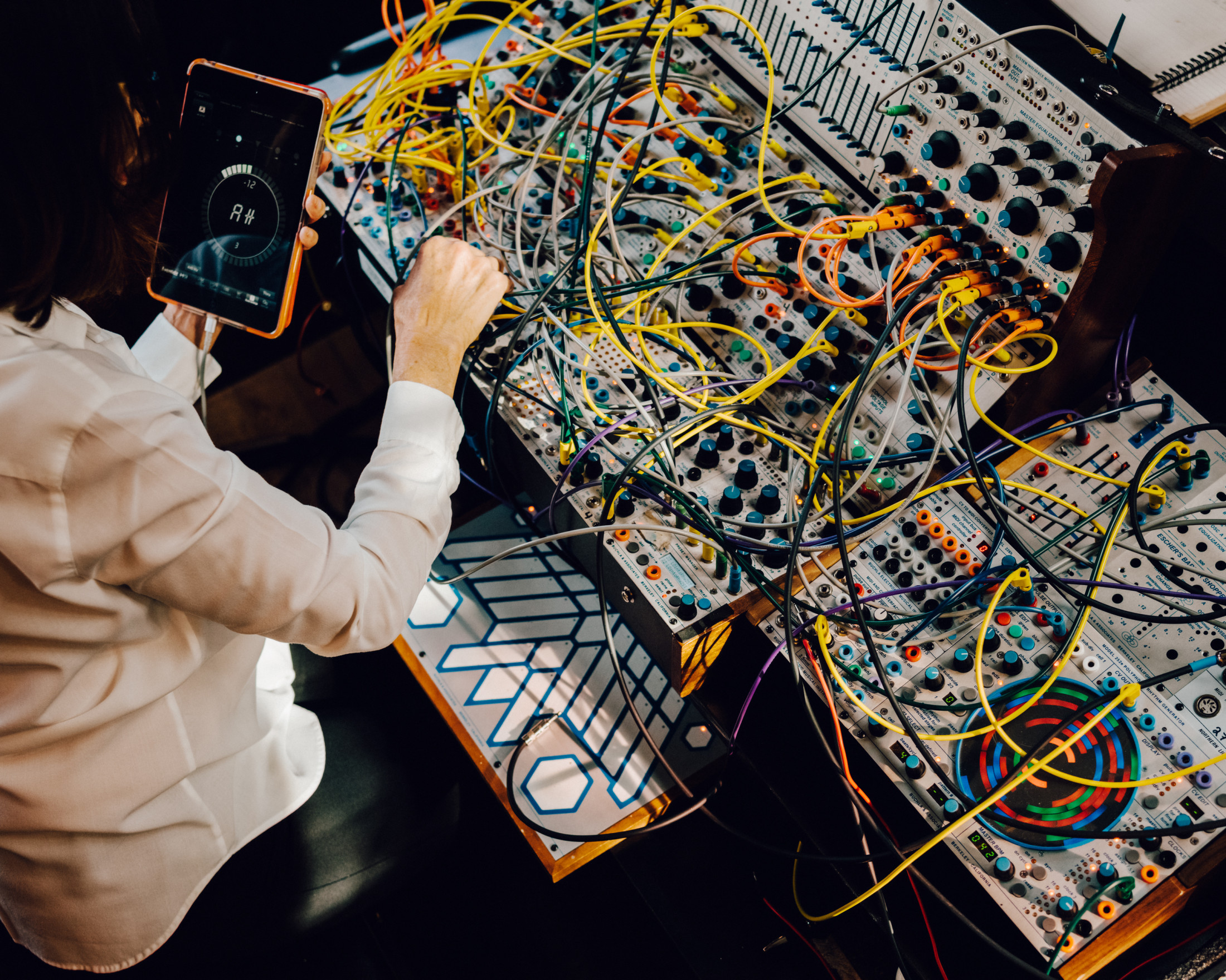 Suzanne with her Buchla. Image from The Caret.